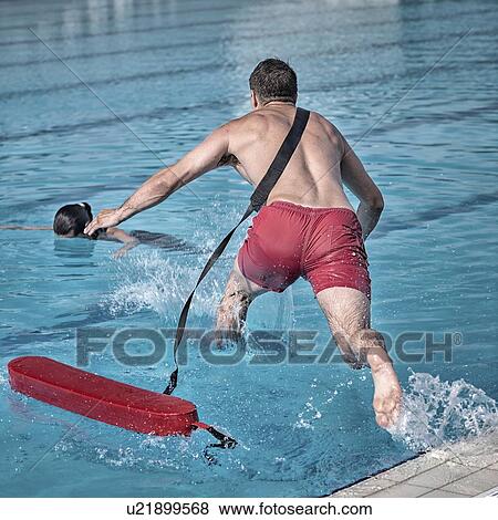 Stock Photo - Lifeguard jumping into pool. Fotosearch