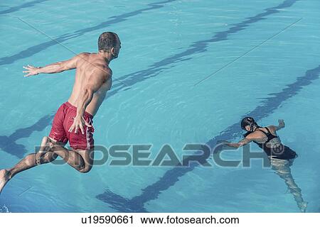 Stock Image - Lifeguard jumping to the rescue. Fotosearch