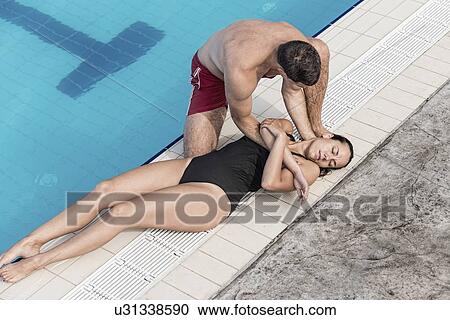 Stock Image - Lifeguard rescue procedure. Fotosearch