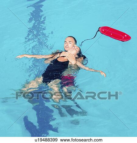 Stock Photo - Lifeguarding rescuing woman. Fotosearch