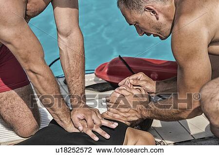 Stock Image - Lifeguards performing CPR. Fotosearch