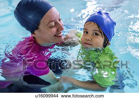 Picture - Little boy learning to swim. Fotosearch