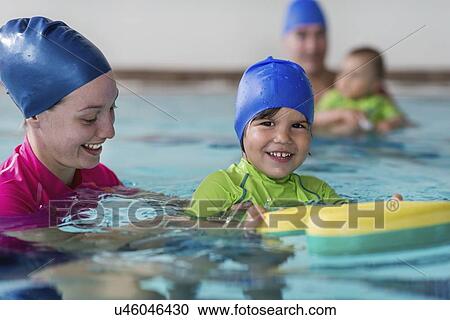 Stock Image - Little boy learning to swim. Fotosearch