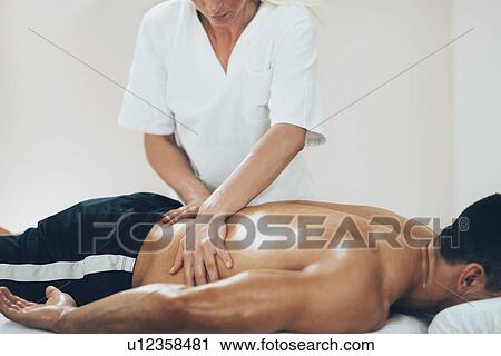 Lower back massage View Large Photo Image Stock Image - Lower back massage. Fotosearch