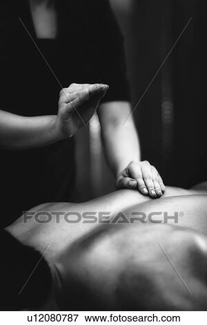 Stock Photo - Lower back massage. Fotosearch