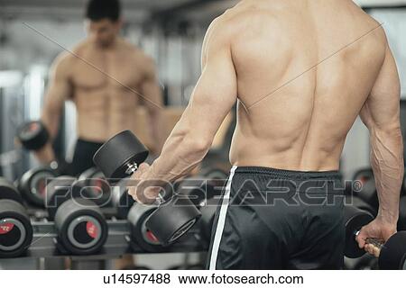 Stock Photo - Man exercising with weights. Fotosearch