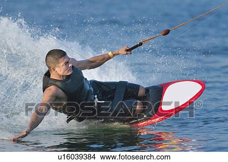 Picture - Man kneeboarding. Fotosearch