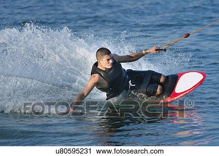 Stock Image - Man kneeboarding. Fotosearch