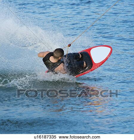 Stock Photography - Man kneeboarding. Fotosearch