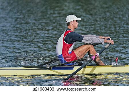Stock Image - Man rowing scull. Fotosearch