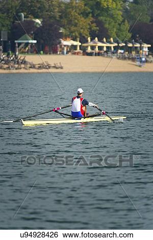 Stock Photograph - Man rowing scull. Fotosearch