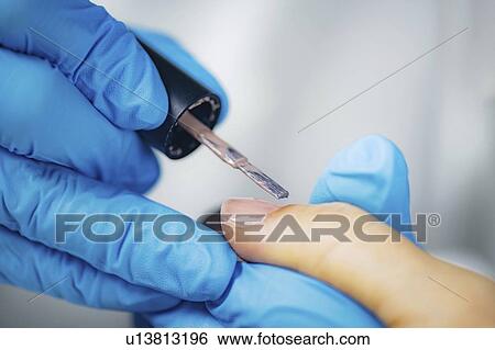 Stock Photograph - Manicurist painting nails. Fotosearch