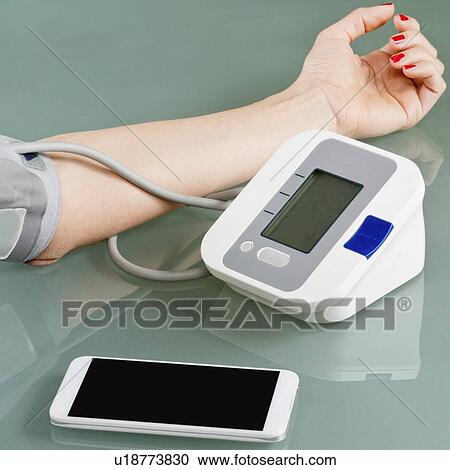Measuring blood pressure at home View Large Photo Image Stock Image - Measuring blood pressure at home. Fotosearch