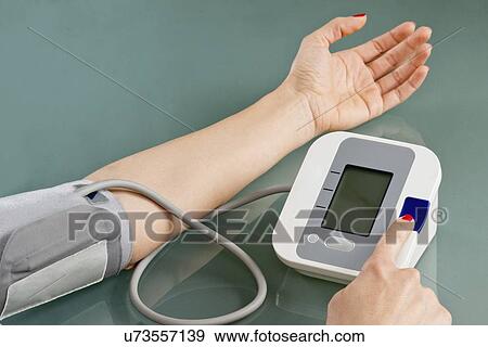 Measuring blood pressure at home View Large Photo Image Stock Photo - Measuring blood pressure at home. Fotosearch