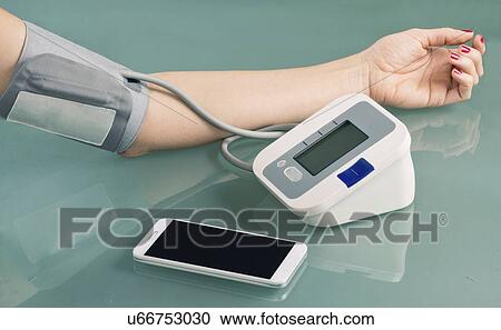 Stock Image - Measuring blood pressure. Fotosearch