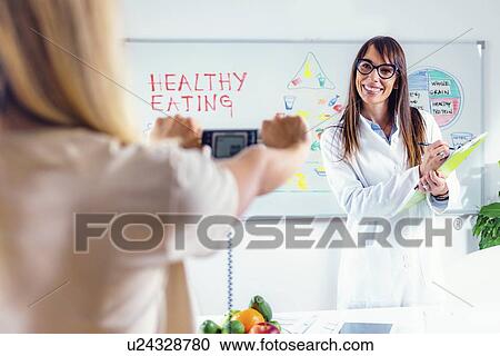 Stock Image - Measuring body fat. Fotosearch