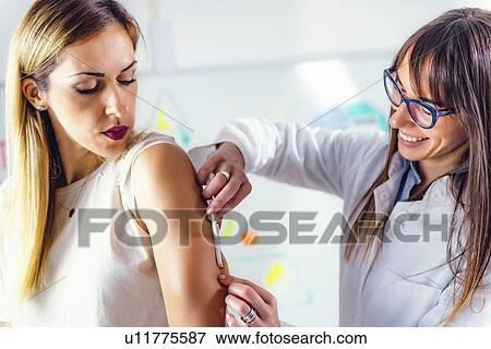 Stock Photo - Measuring body fat with callipers. Fotosearch