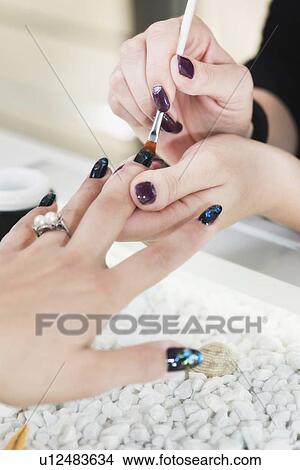 Nail technician painting nails View Large Photo Image Picture - Nail technician painting nails. Fotosearch