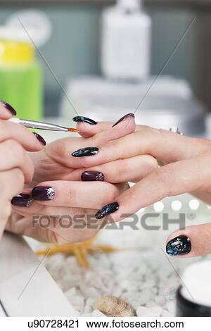Nail technician painting nails View Large Photo Image Stock Image - Nail technician painting nails. Fotosearch