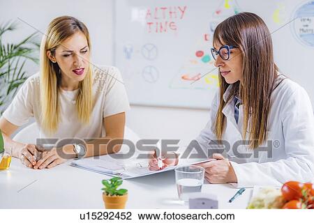Nutritionist with female patient View Large Photo Image Stock Image - Nutritionist with female patient. Fotosearch