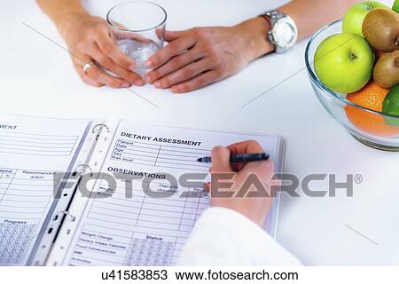 Stock Image - Nutritionist with female patient. Fotosearch