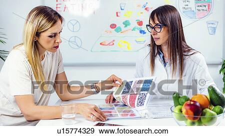 Stock Photo - Nutritionist with female patient. Fotosearch