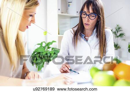 Nutritionist with female patient View Large Photo Image Stock Photo - Nutritionist with female patient. Fotosearch