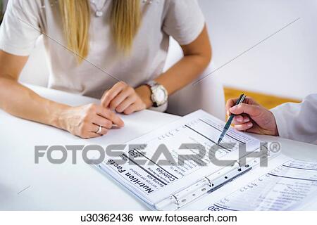 Nutritionist with female patient View Large Photo Image Stock Photograph - Nutritionist with female patient. Fotosearch