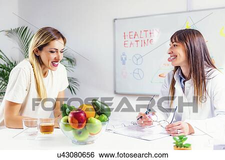Stock Photograph - Nutritionist with female patient. Fotosearch