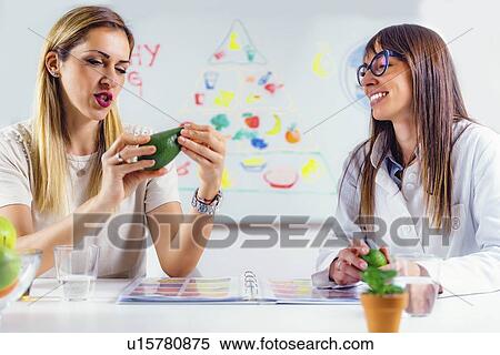 Stock Photography - Nutritionist with female patient. Fotosearch