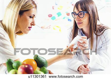 Nutritionist with food pyramid View Large Photo Image Stock Image - Nutritionist with food pyramid. Fotosearch