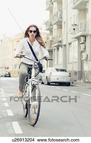 Picture - Office worker using e-bike to commute. Fotosearch