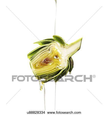 Oil pouring on artichoke View Large Photo Image Picture - Oil pouring on artichoke. Fotosearch