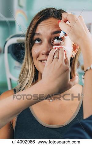 Ophthalmologist applying eye drops View Large Photo Image Stock Photograph - Ophthalmologist applying eye drops. Fotosearch