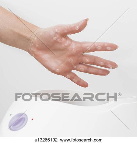 Stock Image - Paraffin wax hand treatment. Fotosearch