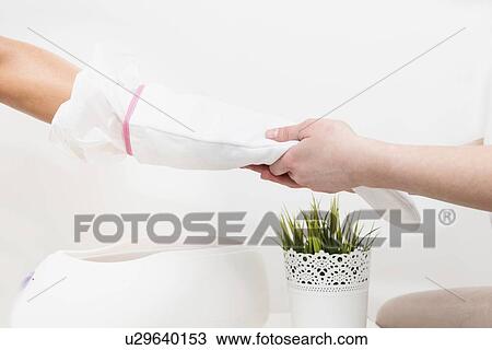 Stock Image - Paraffin wax hand treatment. Fotosearch