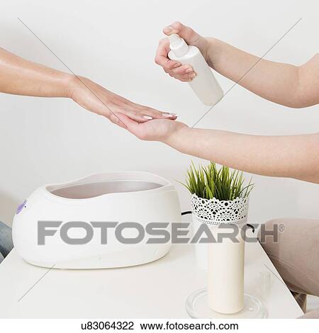 Stock Image - Paraffin wax hand treatment. Fotosearch