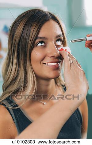 Stock Image - Pen light eye exam. Fotosearch