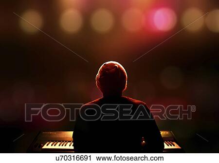Stock Image - Person playing piano. on stage.. Fotosearch