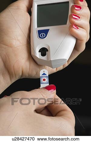 Stock Image - Personal blood glucose meter. Fotosearch