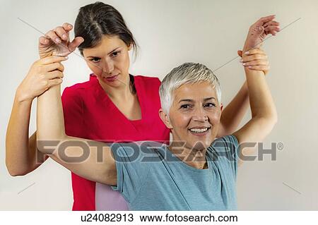 Physical therapist examining patient View Large Photo Image Stock Image - Physical therapist examining patient. Fotosearch