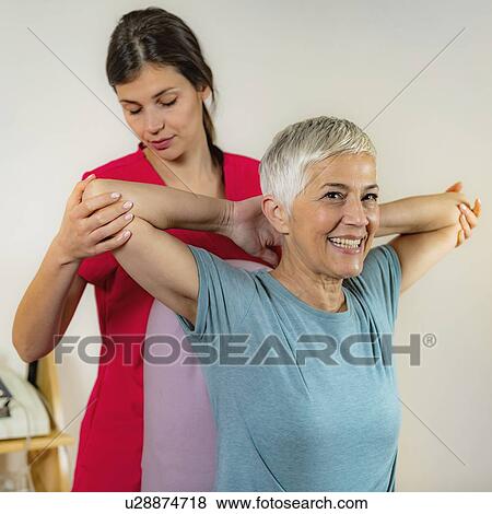 Physical therapist examining patient View Large Photo Image Stock Photo - Physical therapist examining patient. Fotosearch