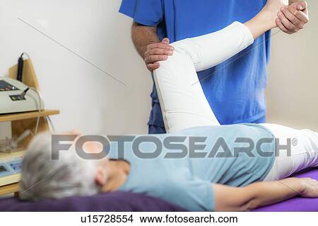 Physical therapist examining patient's leg View Large Photo Image Picture - Physical therapist examining patient's leg. Fotosearch