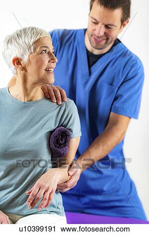 Physical therapist examining patient's arm View Large Photo Image Stock Image - Physical therapist examining patient's arm. Fotosearch