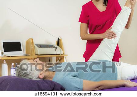 Physical therapist examining patient's leg View Large Photo Image Stock Image - Physical therapist examining patient's leg. Fotosearch