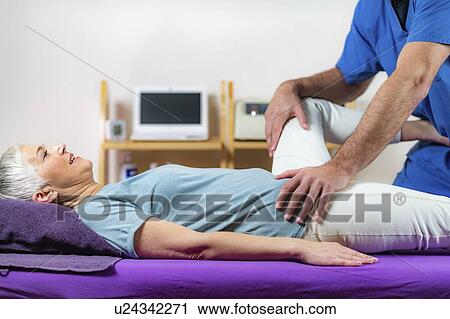 Physical therapist examining patient's leg View Large Photo Image Stock Image - Physical therapist examining patient's leg. Fotosearch