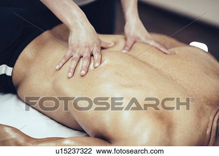 Physical therapist massaging back View Large Photo Image Stock Image - Physical therapist massaging back. Fotosearch