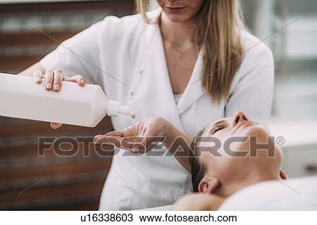 Stock Image - Physical therapist massaging female patient. Fotosearch