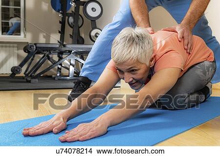 Picture - Physical therapist stretching senior woman. Fotosearch