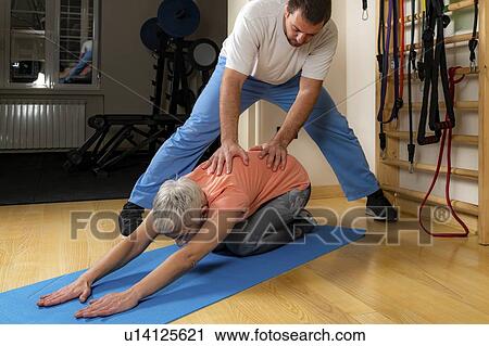 Physical therapist stretching senior woman View Large Photo Image Stock Image - Physical therapist stretching senior woman. Fotosearch